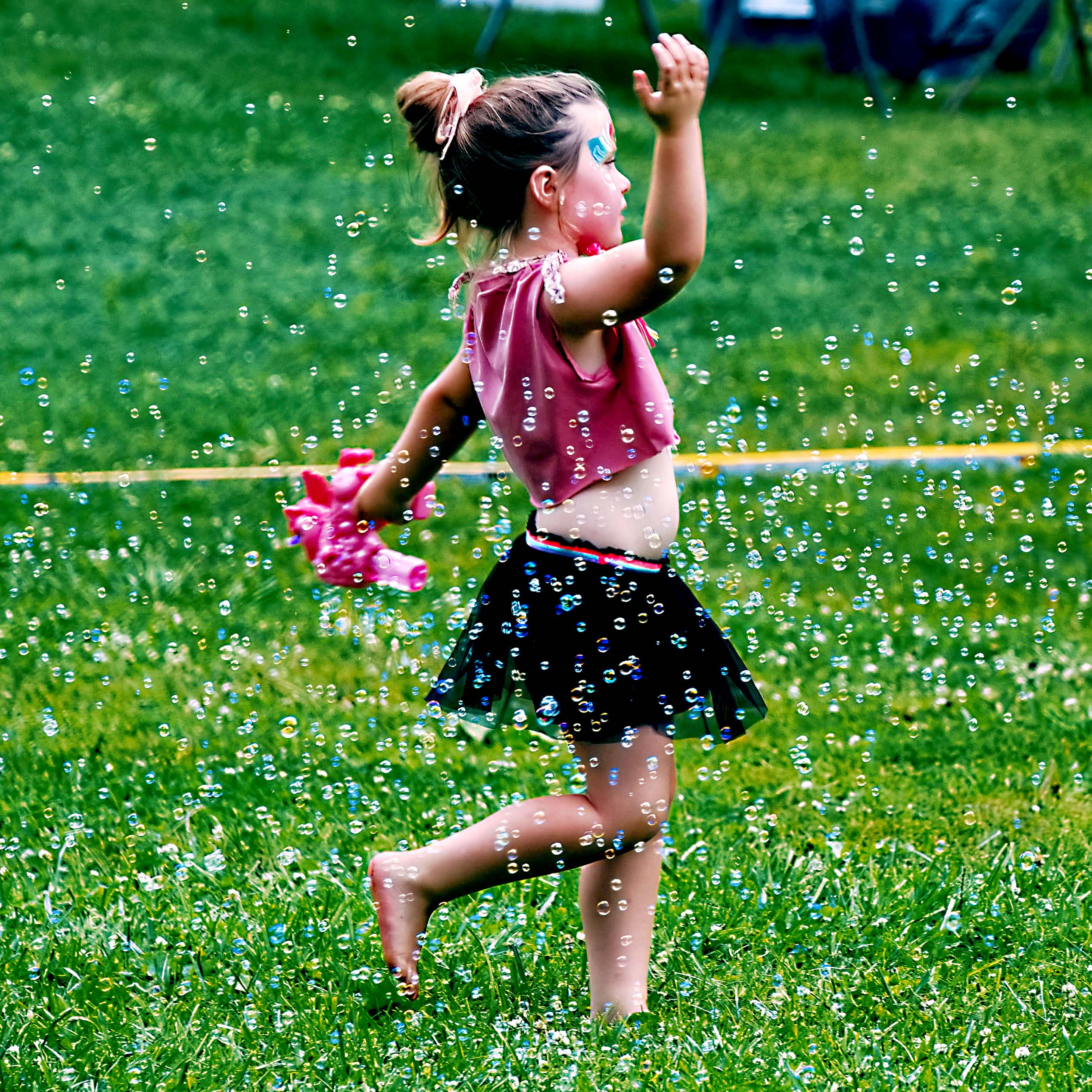 A little girl dances and twirls in a field of bubbles Friday.